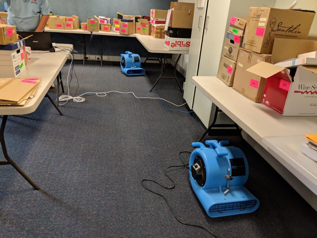 Air blowers drying wet carpets after flood damage Melbourne